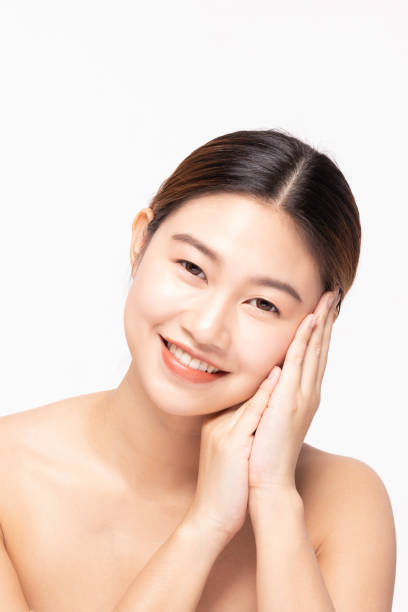 istock Attractive Charming Asian young woman smile with white teeth and touching soft cheek feeling so happy and cheerful with healthy Clean and Fresh Skin,isolated on white,Beauty Cosmetology Concept 1166193710