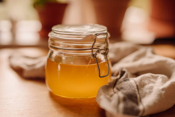 Ghee clarified butter in jar Ghee clarified butter in jar
photo taken indoors in kitchen of full newly homemade ghee ghee stock pictures, royalty-free photos & images