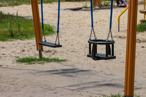 istock children empty swing in the playground, close-up 1166197753