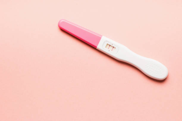 istock Positive pink plastic pregnancy test on pink background. 1166198799
