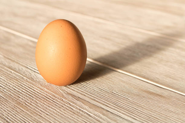 istock Chicken egg on a wooden table. Close up. 1166201295