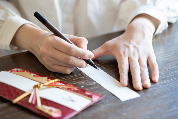 istock Young woman hand writing congratulation bag 1166202879