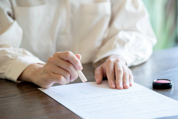 Young woman imprinting documents at desk