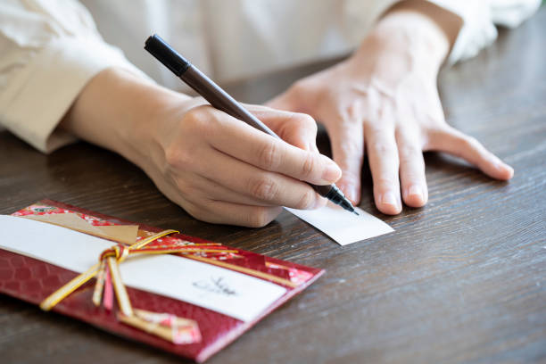 istock Young woman hand writing congratulation bag 1166202894