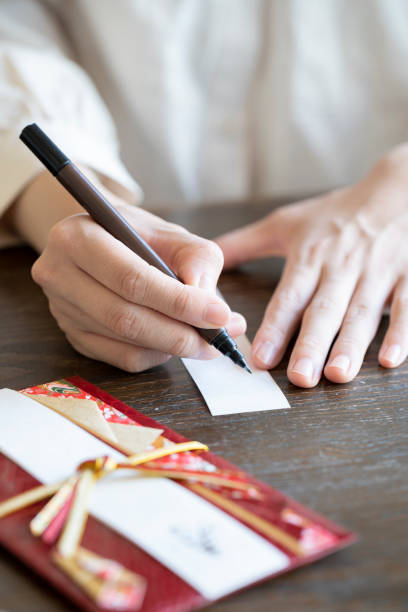 istock Young woman hand writing congratulation bag 1166202931