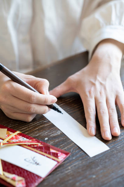 istock Young woman hand writing congratulation bag 1166202956