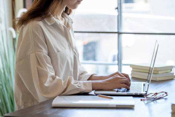 istock The hand of a young woman working at remote work 1166203002