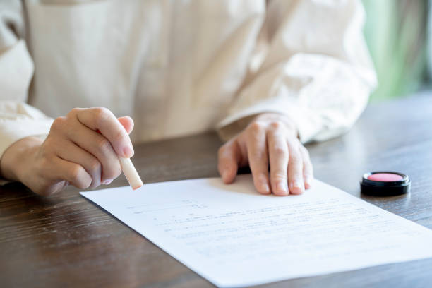 istock Young woman imprinting documents at desk 1166203890