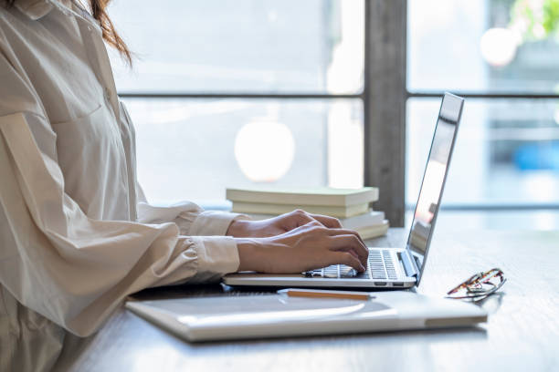istock The hand of a young woman working at remote work 1166203918