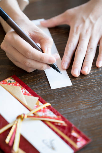istock Young woman hand writing congratulation bag 1166203939
