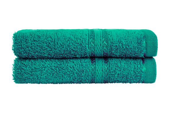 istock Green bath towels in stack. Isolated over white background with clipping path. 1166204174