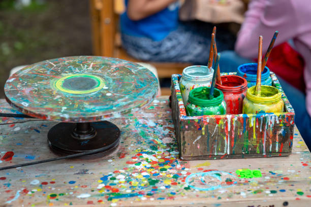 Containers with different colors the artist's outdoor workshop.