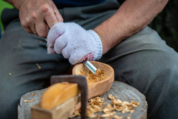 istock Craftsman demonstrates the process of making wooden spoons handmade using tools. National crafts concept. 1166205030