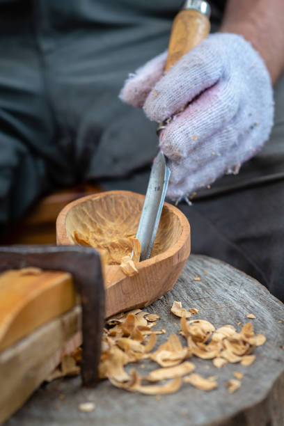 istock Craftsman demonstrates the process of making wooden spoons handmade using tools. National crafts concept. 1166205103