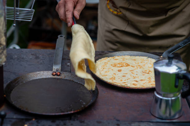 istock A man in an open-air picnic baked pancakes. 1166205124
