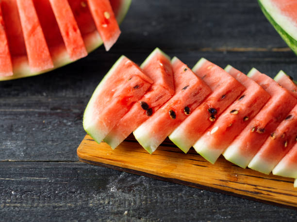 istock Sliced delicious ripe watermelon on the table close-up 1166205518