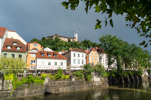 Ljubljana, Slovenia. August 3, 2019.  the houses on the Ljubljanica riverside with the castle in the background