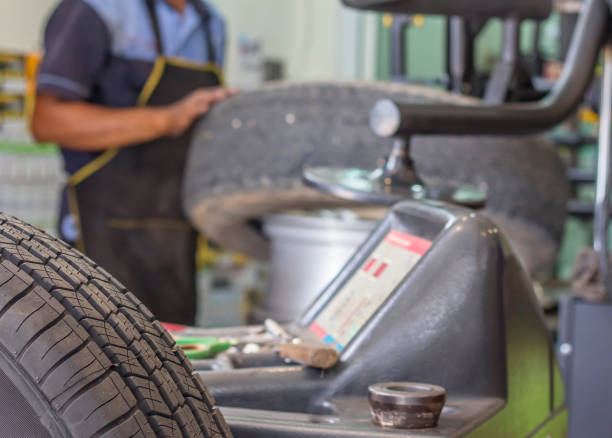 istock Engineer balancing car wheel on balancer in workshop,focus wheel tire. 1166205792