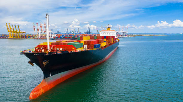 istock Container ship carrying container in import export business logistic and transportation of international by container ship in the open sea. 1166207798