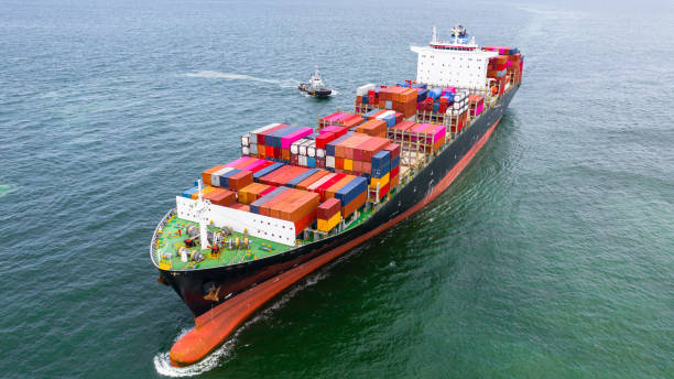istock Container ship carrying container in import export business logistic and transportation of international by container ship in the open sea. 1166207834