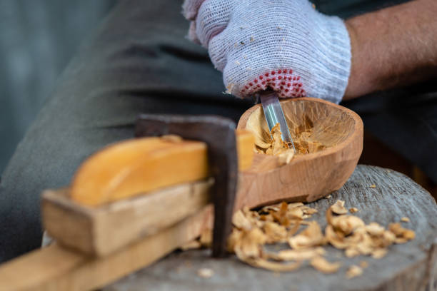 istock Craftsman demonstrates the process of making wooden spoons handmade using tools. National crafts concept. 1166208433