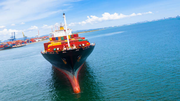 istock Container ship carrying container in import export business logistic and transportation of international by container ship in the open sea. 1166208771