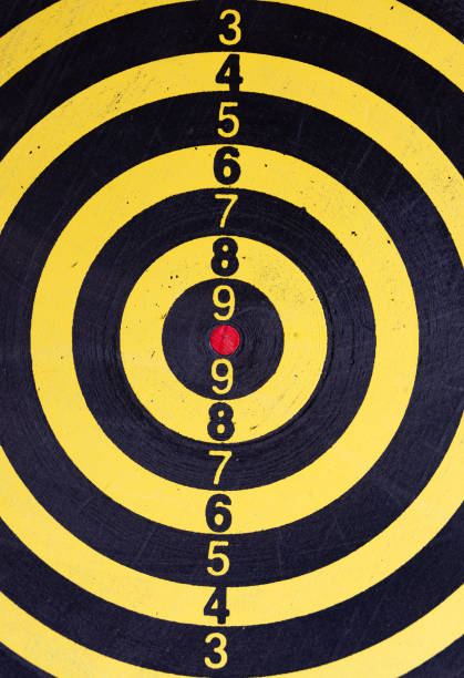 black and yellow target with red bulls eye - bulls eye dart target dartboard imagens e fotografias de stock