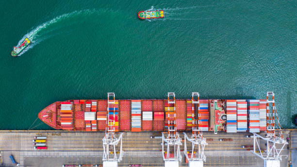 istock Container ship carrying container in import export business logistic and transportation of international by container ship in the open sea. 1166209012