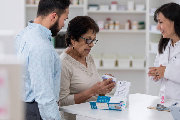 istock Pharmacy customer examines box of medication 1166209343