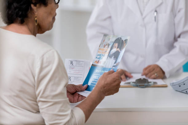 istock Senior woman holds brochure explaining flu medication 1166209394