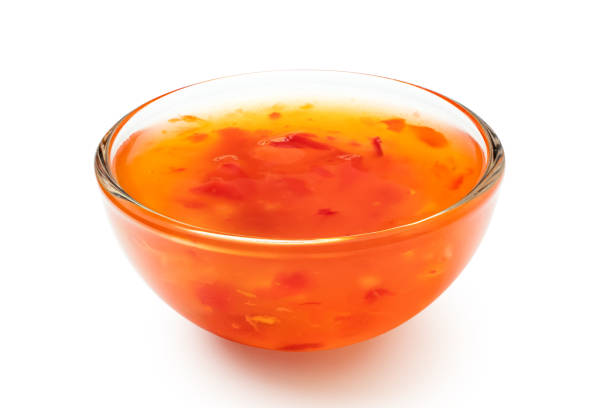 istock Sweet chilli sauce in a glass bowl isolated on white. 1166209442