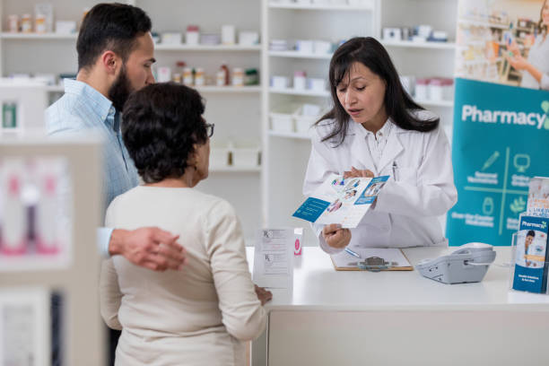 istock Pharmacist discusses pharmacy services with customers 1166209452