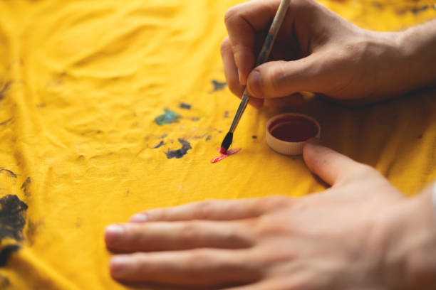 istock drawing with a brush on a t-shirt, personal unique clothes  design concept 1166209705