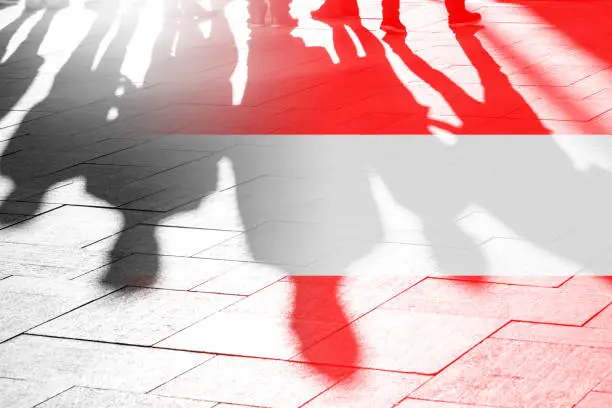 Austrian Flag and Shadows of People - concept Picture about freedom, independence, refugees, government in Austria