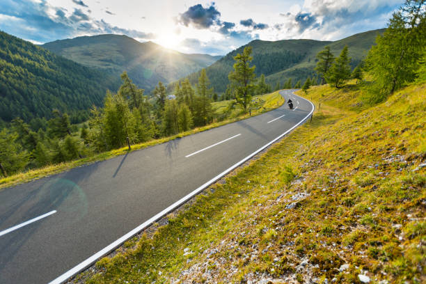 istock Motorcycle driver riding in Alpine highway, Nockalmstrasse, Austria, Europe. 1166212520