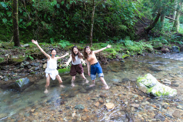 istock 3 women cooling down in cold river 1166212796