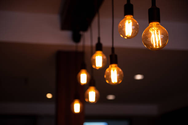 istock Ceiling tungsten lamps with bokeh on dark background 1166215157