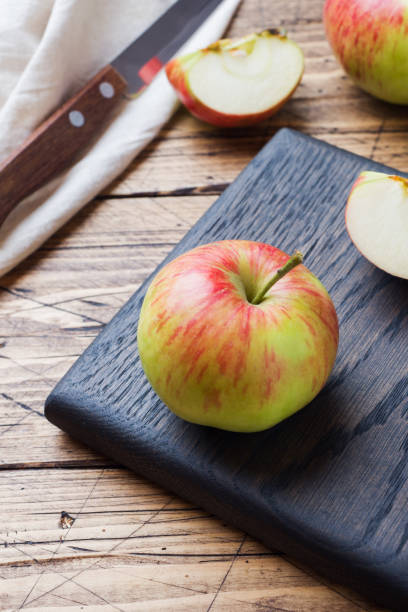 istock Red apples on a wooden table. Apples cut into slices. Copy space. 1166215308