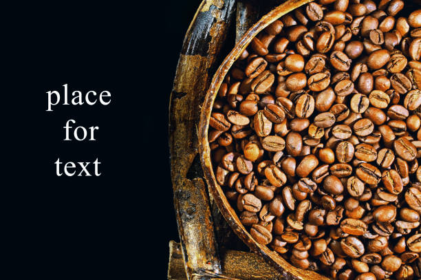Coffee beans lie on a wooden board with space for text or something.