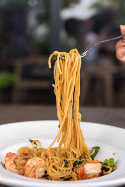 istock Spaghetti with spicy prawn in white dish 1166215351