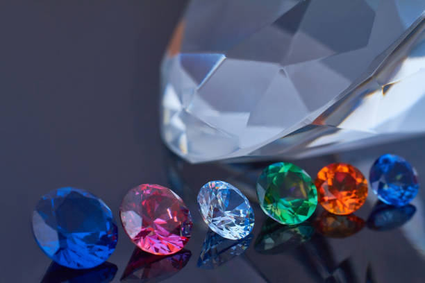 istock Huge diamond and several chic crystals on a deep black mirror surface, shimmer and sparkle 1166217685