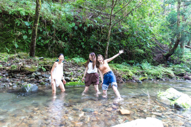 istock 3 women cooling down in cold river 1166217695