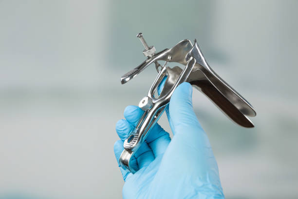 istock Doctor's hand with medical glove holding a speculum 1166220155