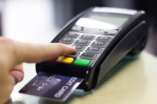 istock Hand press pin processed on credit card machine in store, close up. 1166221114