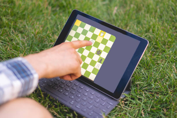 istock playing chess on a digital device outdoor, mental activity 1166222313