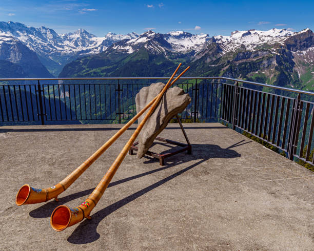 Alpine horn With the Swiss Alps in the background alpenhorn stock pictures, royalty-free photos & images
