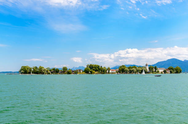 Fraueninsel, Frauenchiemsee on lake Chiemsee with boat, Sailboat, church, monastery. Bavaria, Bayern, Germany