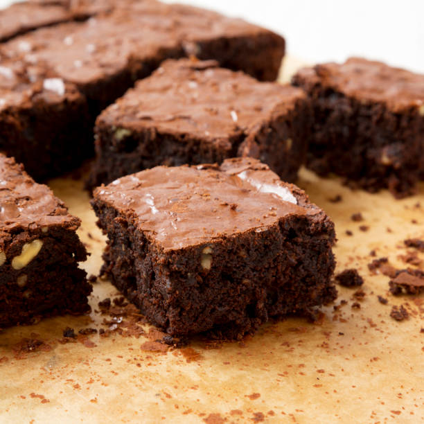 istock Home-baked chocolate brownies on a baking sheet, side view. Closeup. 1166224649