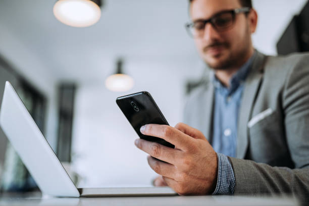 istock Closeup of entrepreneur using mobile phone in office. 1166228106