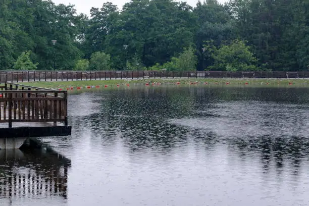 Photo of A view of a artificial lake on a rainy day in rila park near town Dupnitsa